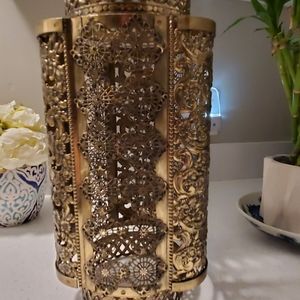 Moroccan gold tone metal candle sconce. Very light weight.